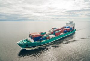 Aerial view of container vessel sailing in open sea