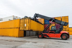 Mobile stacker handler in action at a container terminal.
